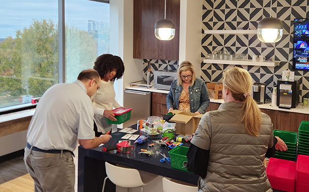 Edge team members putting boxes together for Samaritan’s Purse.
